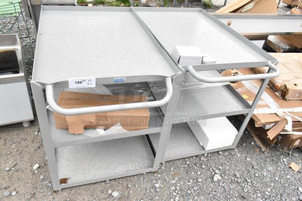 Gray metal 3-tier cart, brand new with minor scratches and dents. Features label "AVEX". Auction for two units.