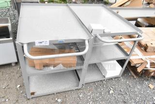 Gray metal 3-tier cart, brand new with minor scratches and dents. Features label "AVEX". Auction for two units.