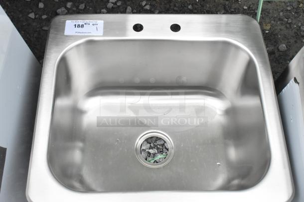 Stainless steel single bay drop-in sink, new with minor scratches. Features two faucet holes and a visible price tag.