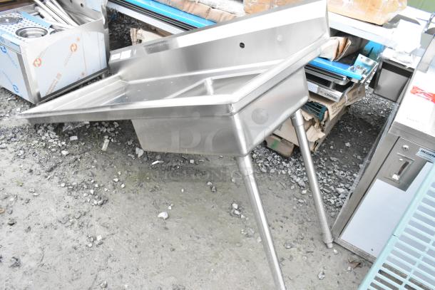 Brand new Regency 600UDT60R stainless steel single bay sink with scratch and dent, missing 2 legs, commercial-grade.
