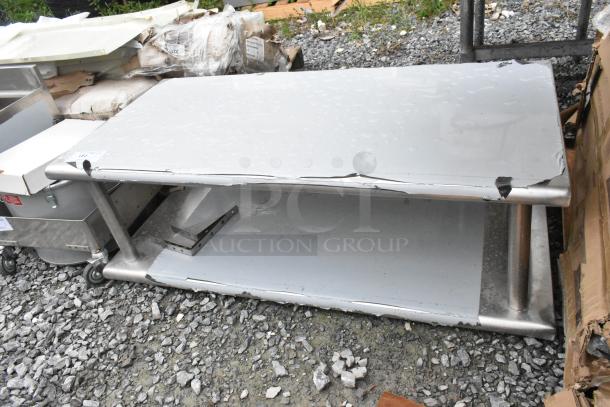 Stainless steel 2-tier shelf, brand new, with visible scratches and dents. Ideal for storage and organization.