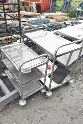 Brand new stainless steel 2 and 3-tier carts on commercial casters, with tags noting "200." Scratch and dent condition.