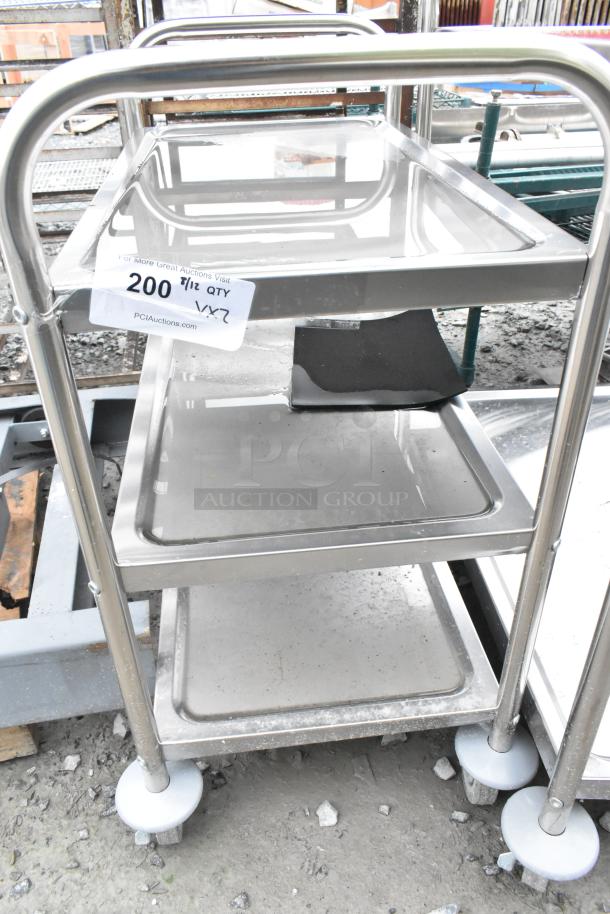 Stainless steel 3-tier cart on commercial casters, brand new with minor scratches, auction label indicating lot 200, qty 12.