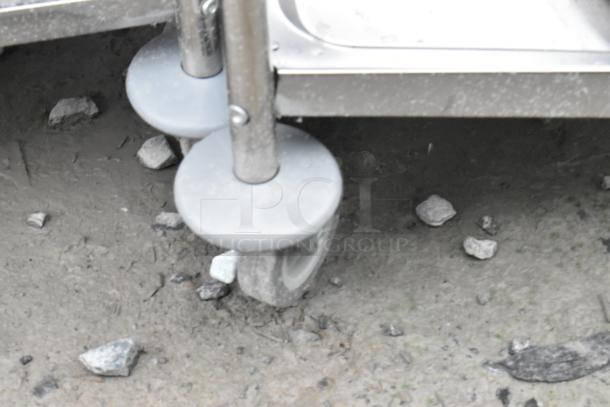 Stainless steel cart with 2 and 3 tiers on commercial casters, scratch and dent condition.