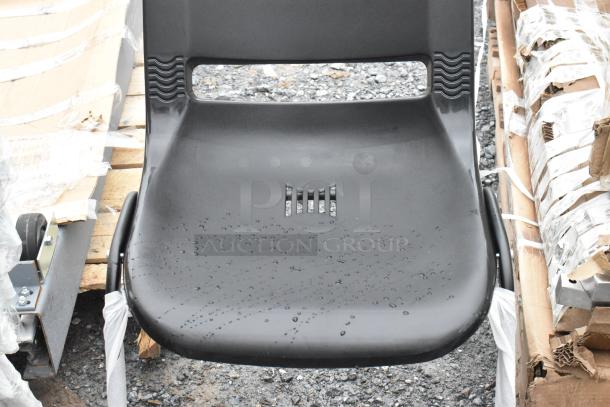 Brand new black poly and metal chair with visible raindrops, slightly scratched surface. Durable and modern design.