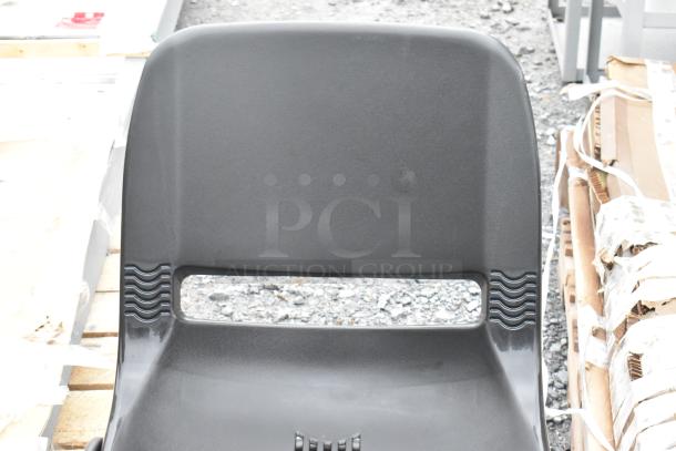 Black poly and metal chair, scratch and dent condition, featuring a modern design with a cut-out backrest.