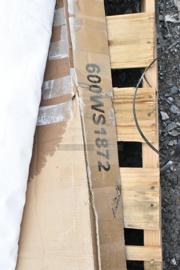 Cardboard box labeled "600WS1872" on a wooden pallet, indicating a Regency 16 gauge stainless steel 18" x 72" heavy-duty wall shelf.
