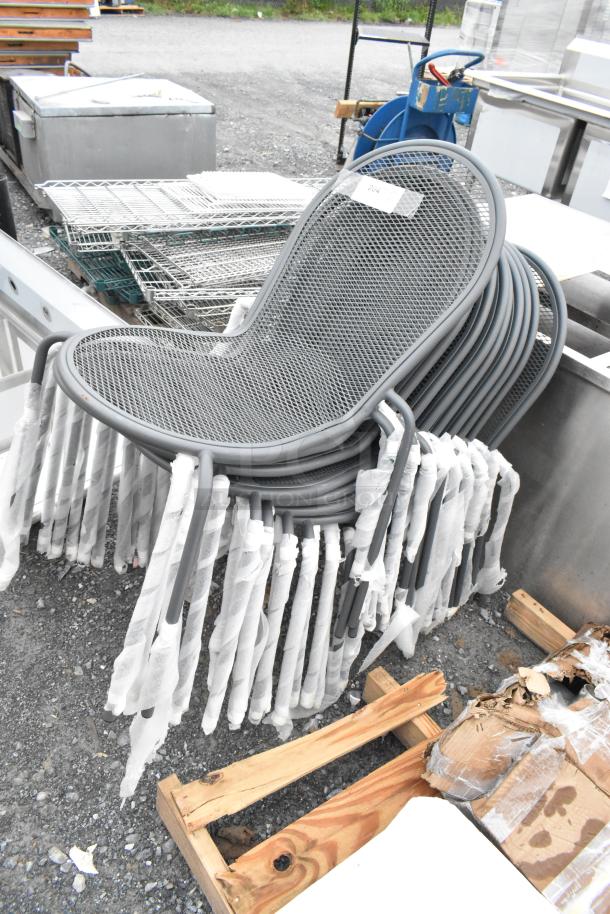 10 new black mesh metal stackable patio chairs, slight scratches, protective wraps on legs, auction lot.