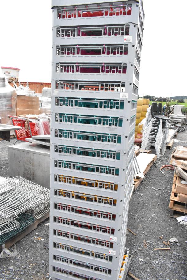Lot of 20 ALL ONE MONEY1 poly dish caddies stacked outdoors. Visible color-coded slots, gray frames, good condition.