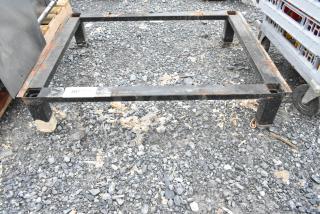 Black metal stand with rust spots, rectangular frame, four legs. Tag with "207" visible. Suitable for industrial use.