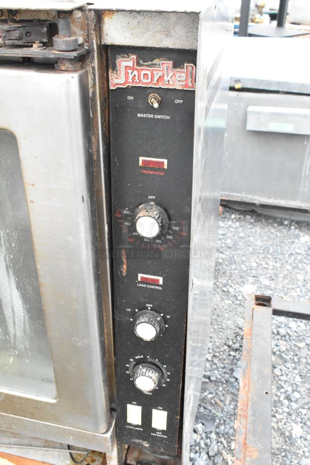 Vulcan Snorkel stainless steel gas convection oven with view-through doors, metal racks, and thermostatic controls. Signs of wear.