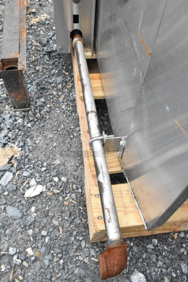 A portion of the Vulcan Snorkel Stainless Steel Commercial Gas Convection Oven showing a metal pipe attachment on wooden pallet.