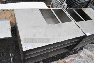 Stainless steel counter with cutout, features three under shelves. Light scratches visible. Tag with auction lot number "212."