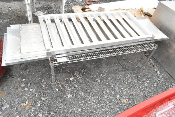 4 various items including a sturdy wire shelf and dunnage rack. Metal pieces visible with minor wear. Bid multiplier: 4x.