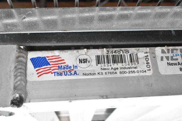Metal wire shelf, labeled "Made in the U.S.A." and "NSF" by New Age Industrial, Norton KS. Rugged construction, ideal for storage.