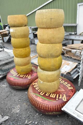 14 stacked cheese wheel decorations, labeled "Parmigiano Reggiano" and "Prima Donna." Ideal for display, with realistic detailing.