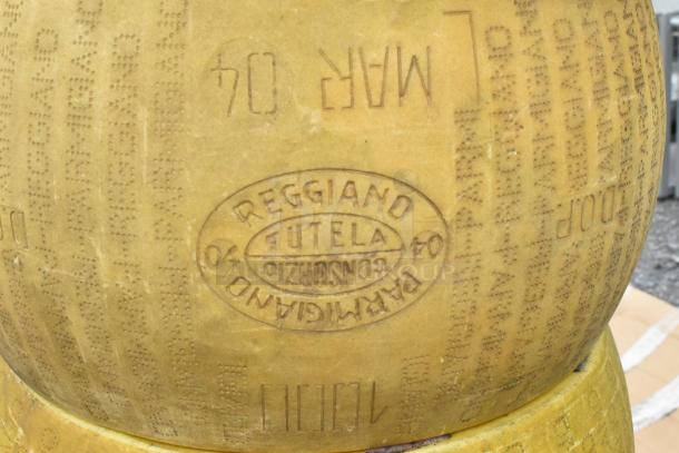 14 decorative wheels of cheese with Parmigiano Reggiano markings, featuring details like "Futela" and "March 04."