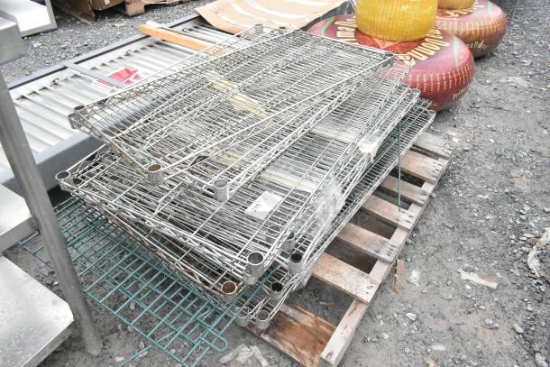 Lot of various wire shelves on a pallet, visible label, suitable for storage, in fair condition.