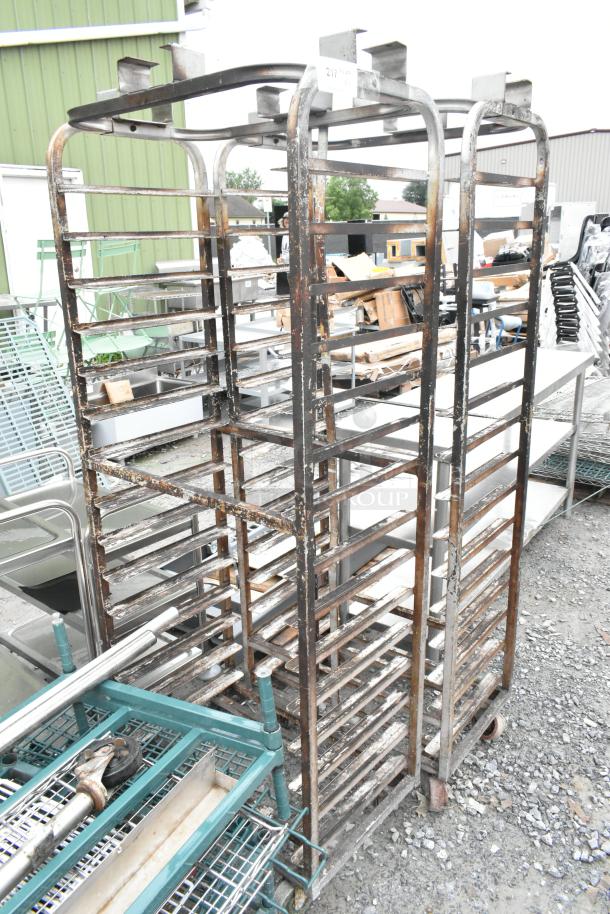 2 metal pan transport racks with top guide, suitable for rack oven. Features commercial casters, showing signs of use.