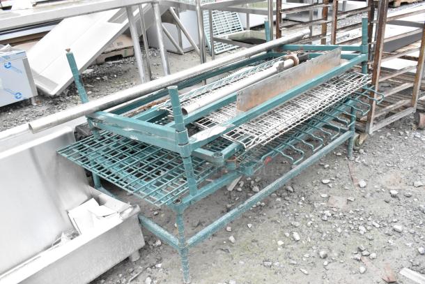 Lot of various items including green dunnage style shelving unit with wire racks and metal pipes. Used condition.