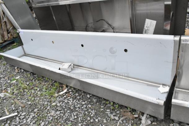 Brand new Regency 600HSMSB1896 wall-mounted hand sink, 96"x17.5", for 4 single-inlet faucets, shown with scratches.