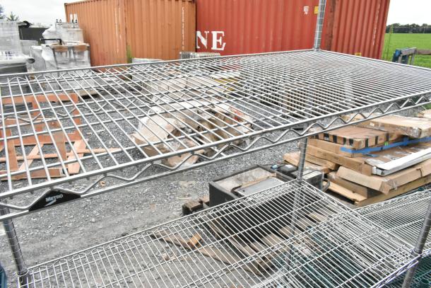 Metro chrome 4-tier wire shelving unit with commercial casters. Good condition. Buyer must dismantle for shipping.