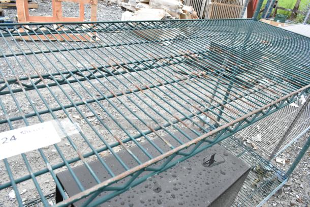 Green finish 3-tier wire shelving unit, used condition. Visible wear includes rust and weathering. Buyer must dismantle.