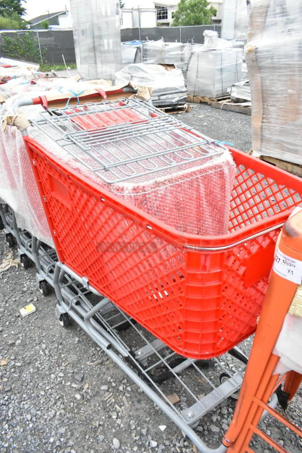 Red Regency 460PSHPCRT74R grocery cart, 7.4 cu. ft., new with minor scratches, red plastic frame, wire basket, bubble wrap.