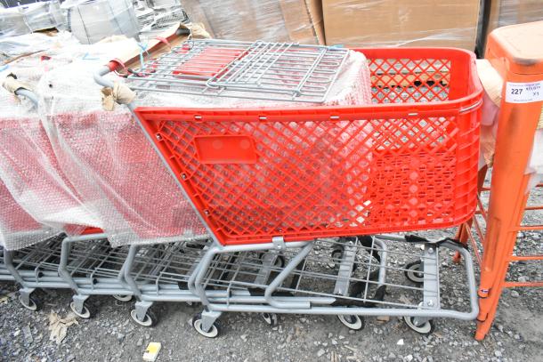 Eight brand new Regency 460PSHPCRT74R red grocery carts, 7.4 cu. ft., partially wrapped in bubble wrap, on sale for scratch and dent.