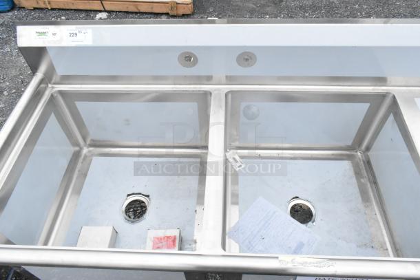 Brand new Regency 600S2242424R stainless steel 2-bay sink with right side drain board, visible labels, minor scratches.