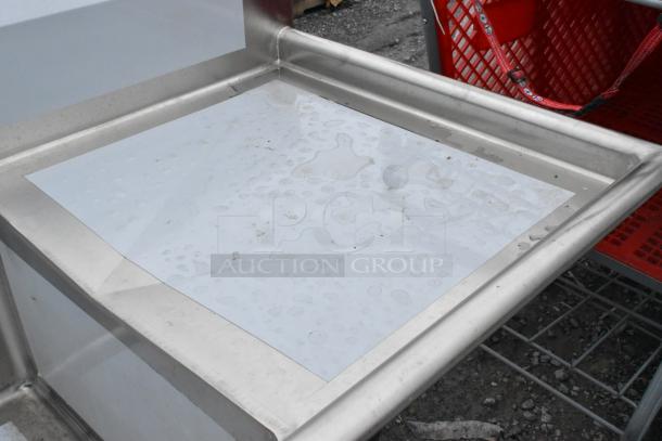 Brand new Regency 600S2242424R stainless steel 2-bay sink with right side drain board, visible protective film.