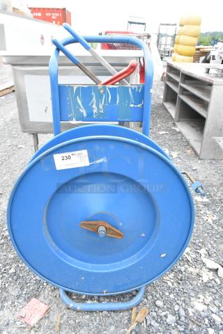 Blue metal pallet banding cart with contents, featuring a large spool and handles, label indicating "230 qty."