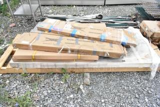 Packaged stainless steel overshelves and accessories on a pallet, labeled "REGGNEY." New condition, scratch and dent items.