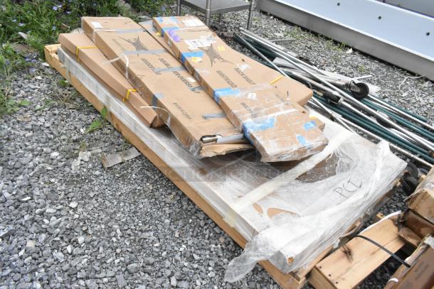 Six new scratch and dent items, including stainless steel overshelves, still in packaging on a wooden pallet.