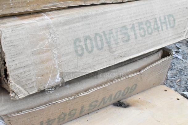 Cardboard boxes labeled "600WS1584HD," containing new scratch and dent items including a stainless steel work table.