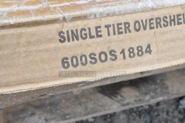 Cardboard box marked "Single Tier Overshelf 600SOS1884." Box contains scratch and dent items for auction.