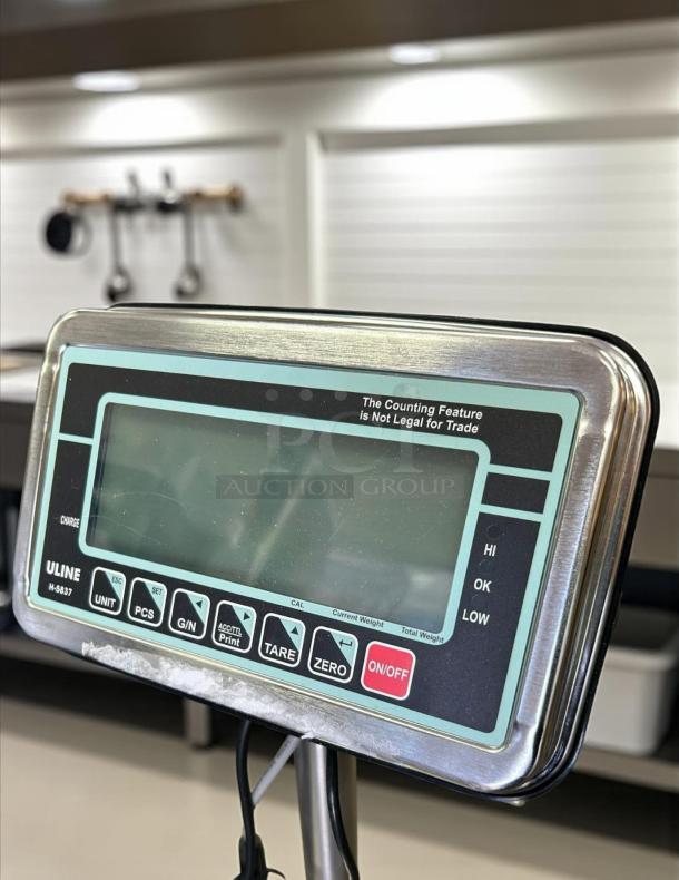 Uline Model H-5837 washdown platform scale, 115v, in great condition. Features a digital display and control panel.