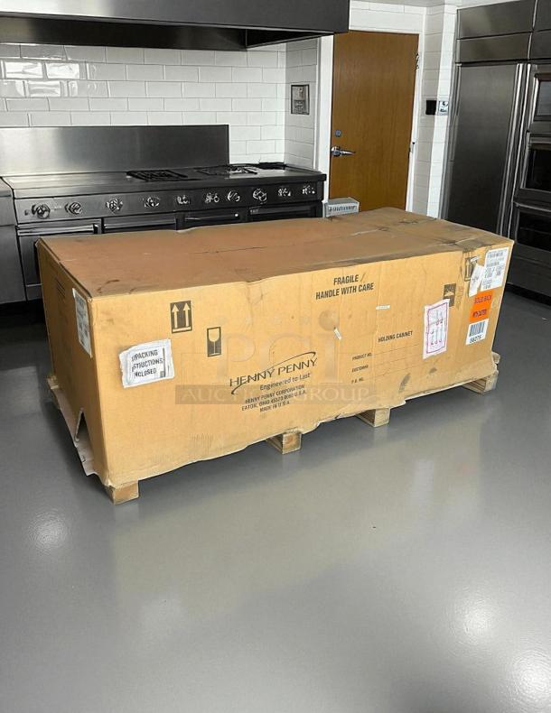 Brand new Henny Penny HHC-900 insulated holding cabinet in shipping box, labeled "handle with care," 120V, SimpleHold controls.