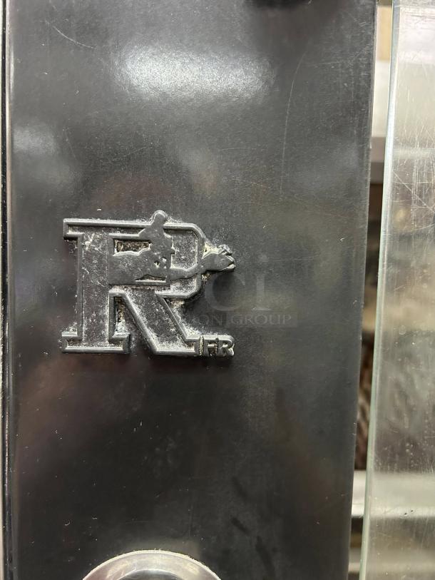 Rotisol USA FB1400-8G-SS gas rotisserie, logo on metal surface, great condition, 48 bird capacity, tested and working.
