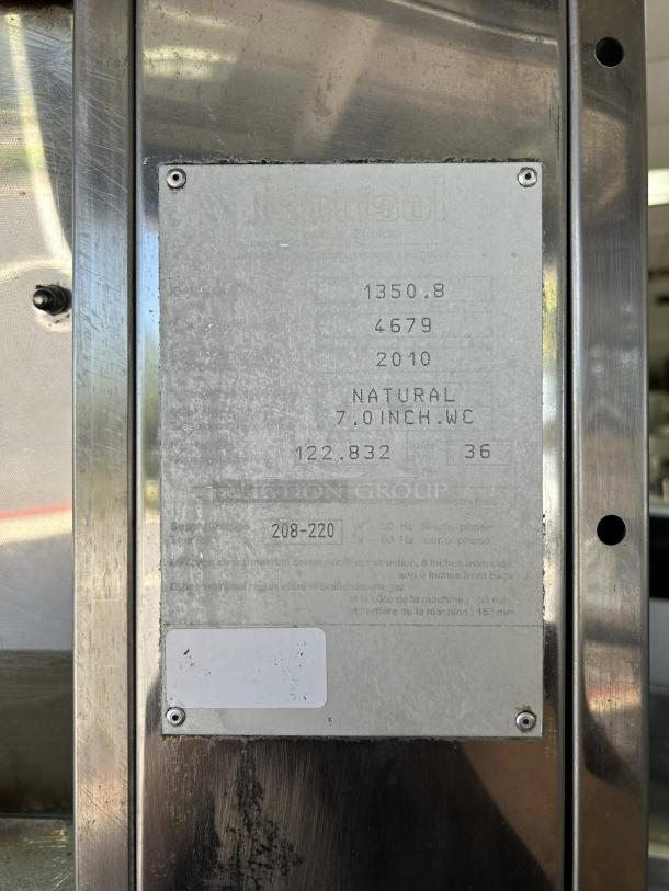 Rotisol USA FB1400-8G-SS gas rotisserie label showing specs: 8 spits, 48 bird capacity, natural gas, model numbers visible.