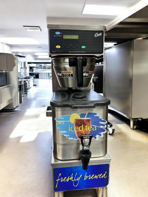 Wilbur Curtis TBP commercial iced tea brewer, 3.5-gallon capacity, in immaculate condition. Features "freshly brewed" signage.