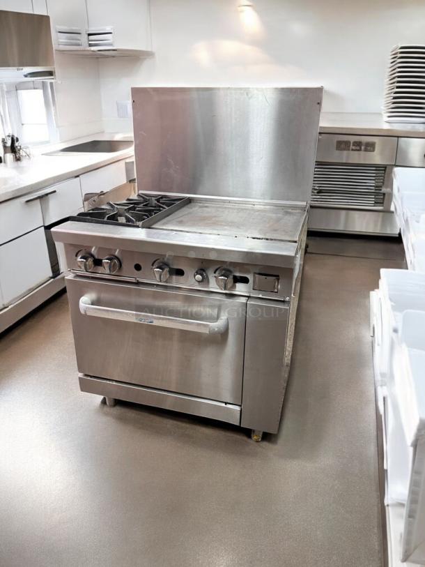 Commercial gas range in excellent condition with 2 burners, 24" griddle, and standard oven. Fully tested and working.