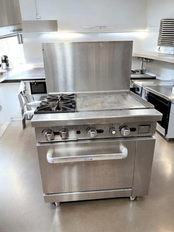 Commercial gas range with 2 burners, 24" griddle, and standard oven. Excellent condition, fully tested and working.