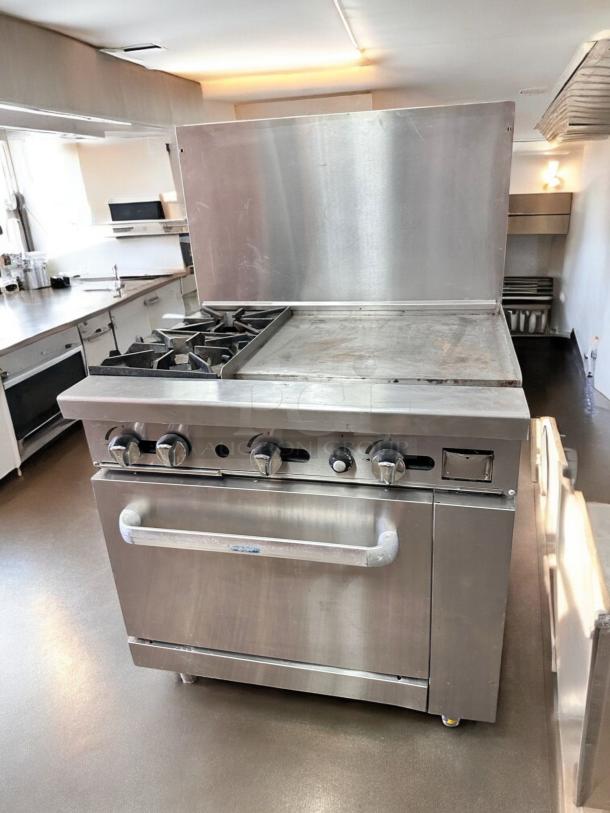 Commercial gas range with 2 burners, 24" griddle, and standard oven. Excellent condition, fully tested and working.