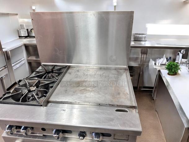 Commercial gas range with 2 burners, 24" griddle, and standard oven in excellent condition. Fully tested and working.