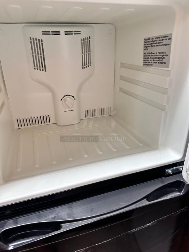 Magic Chef HVDR1040B refrigerator interior, top freezer section in excellent condition, temperature control dial visible.