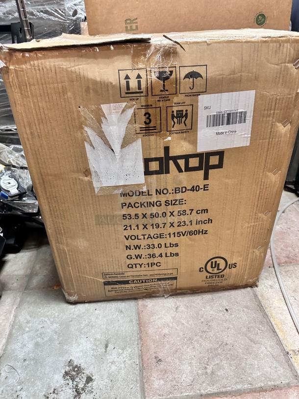 Brand new Zokop BD-40-E compact chest freezer in original box, 1.1 Cu. Ft., 115V. Box details voltage, dimensions, and weight.