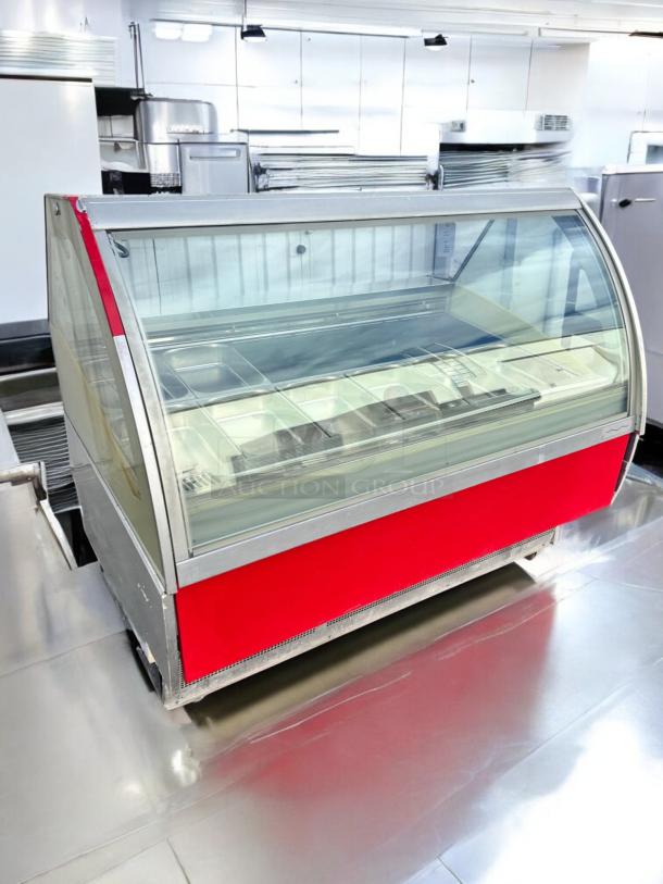 A red and silver commercial display cabinet with a glass front, designed for storing sheet pans, in a clean kitchen setting.