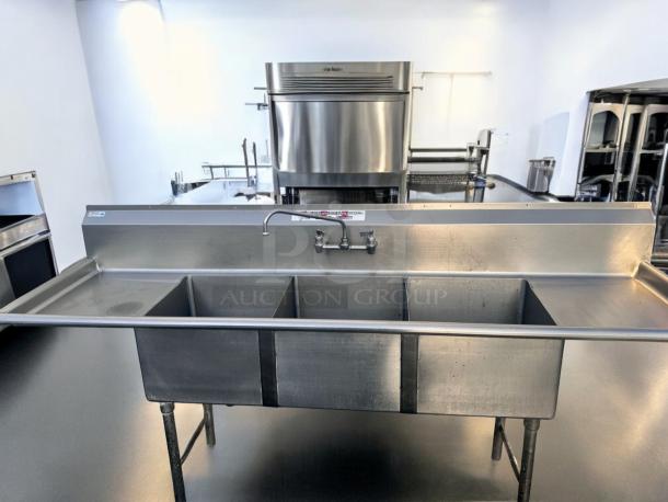 Stainless steel 3-compartment sink with dual drainboards, 96" x 31", excellent condition, fully tested, commercial use.