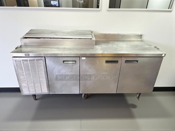Delfield 91in 3-door refrigerated pizza prep table, model 000-20191PTC, in excellent condition, on casters, 115v tested.